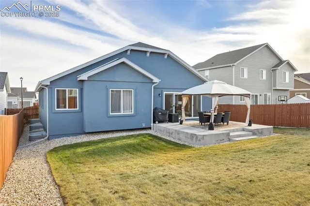 a view of a house with swimming pool and sitting area