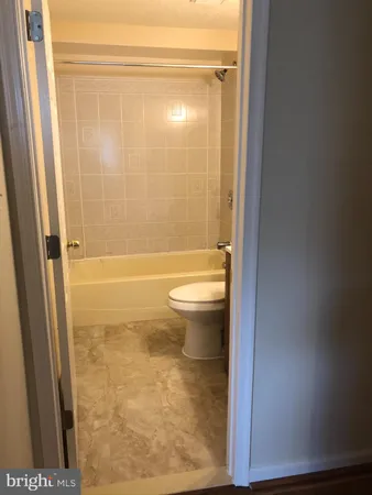 a bathroom with a shower and a toilet