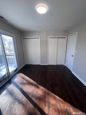 a view of bedroom and bedroom with wooden floor