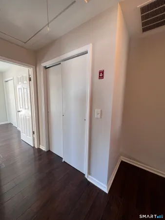 a view of a hallway with wooden floor