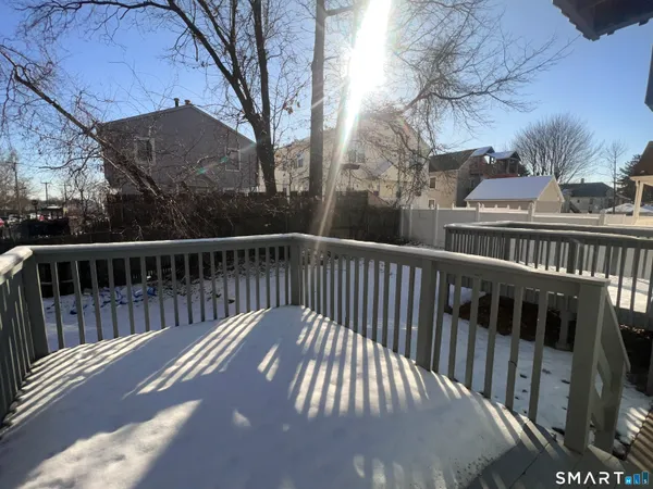 a view of balcony with wooden floor and fence