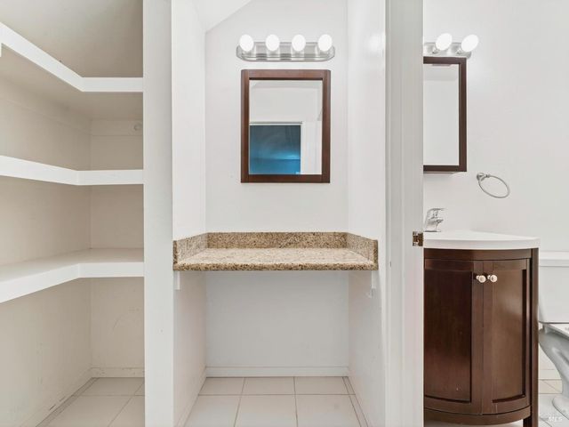a bathroom with a granite countertop sink a toilet and bathtub