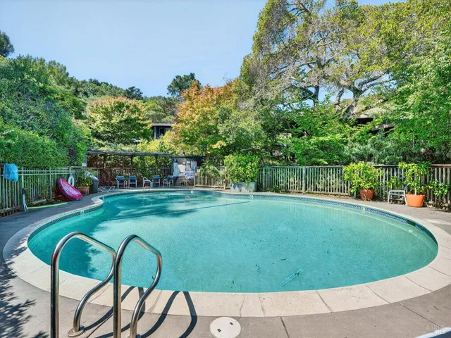 a view of yard with swimming pool and green space