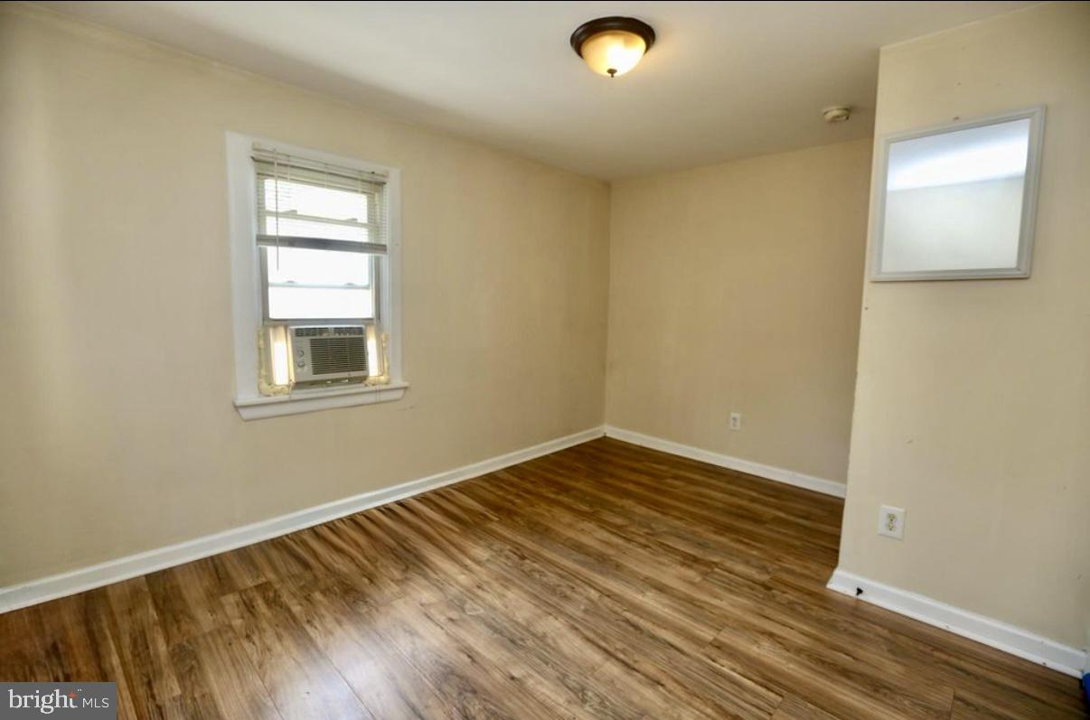 310 Ellis Street Glassboro, NJ 08028 - Photo 6 of 15 an empty room with wooden floor and windows