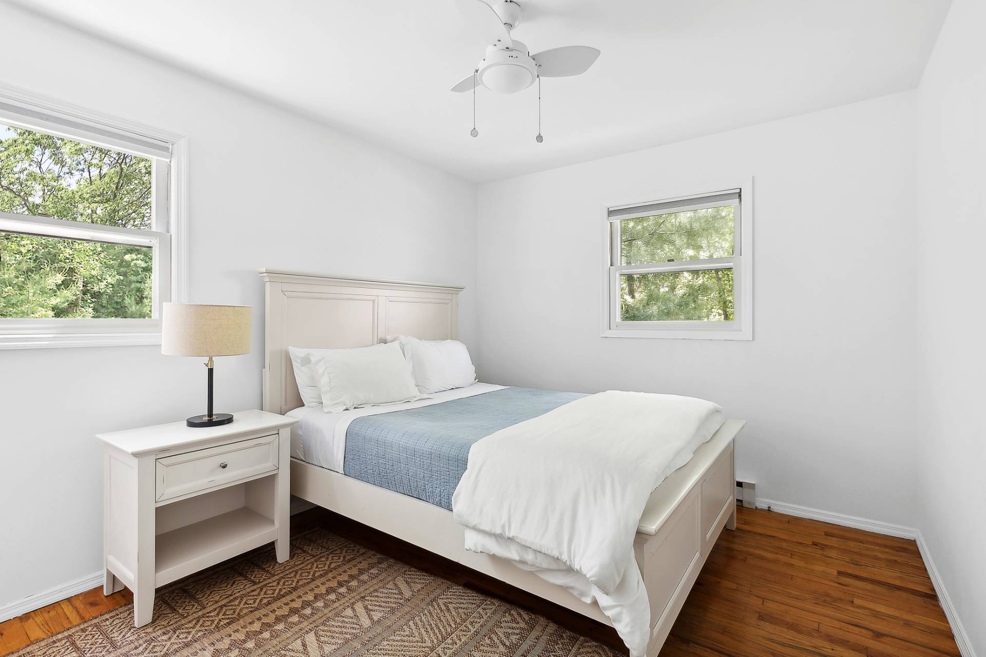 26 Whooping Hollow Road East Hampton, NY 11937 - Photo 11 of 18 a bedroom with a bed lamp and a window