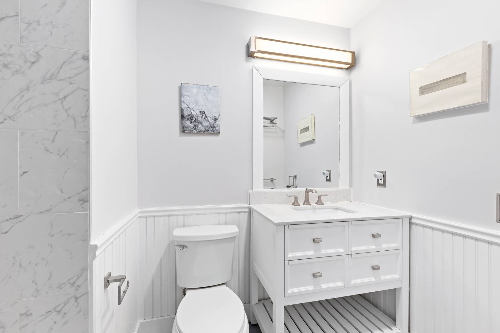 26 Whooping Hollow Road East Hampton, NY 11937 - Photo 12 of 18 a bathroom with a toilet a sink and a mirror