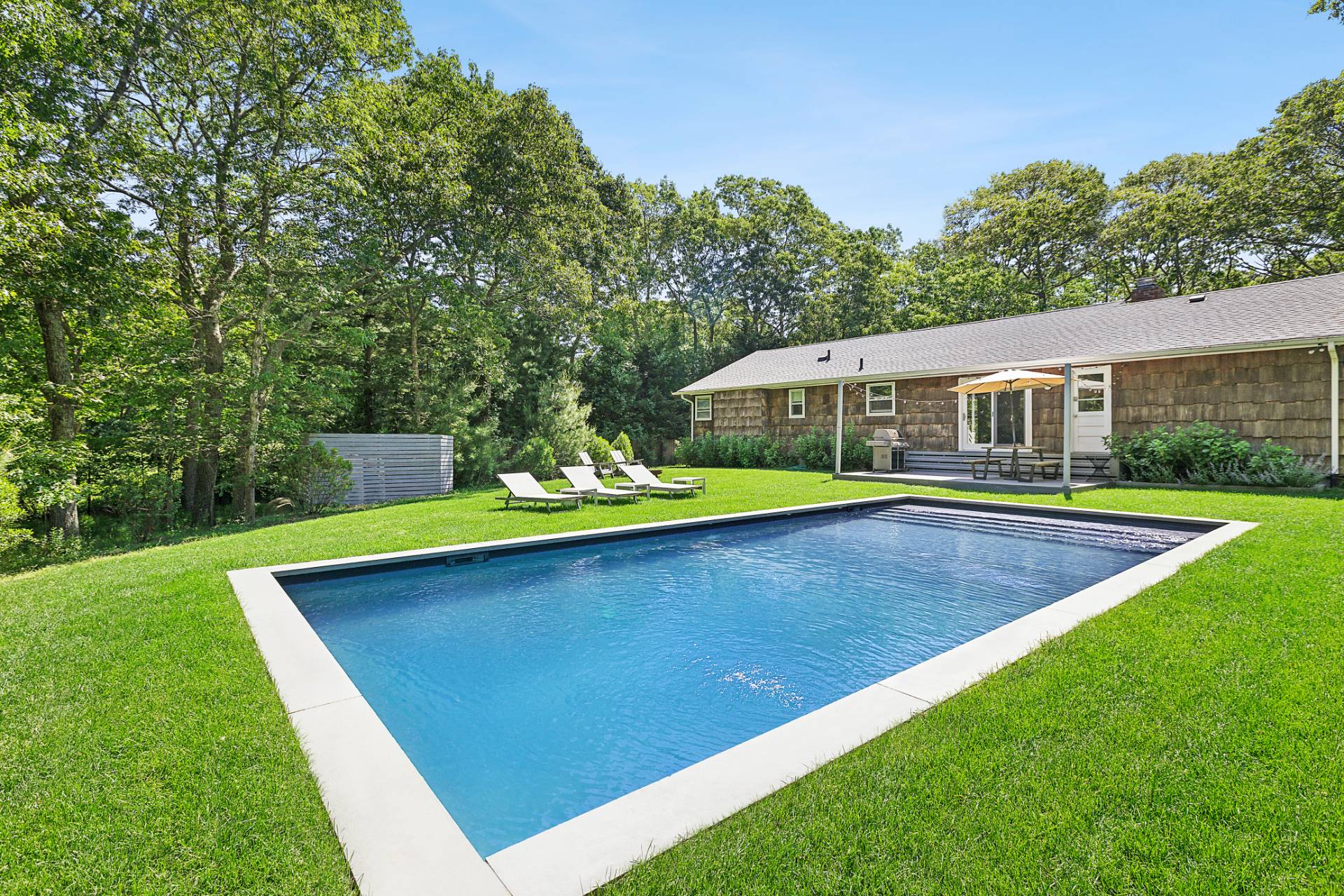 26 Whooping Hollow Road East Hampton, NY 11937 - Photo 18 of 18 a view of a house with a backyard