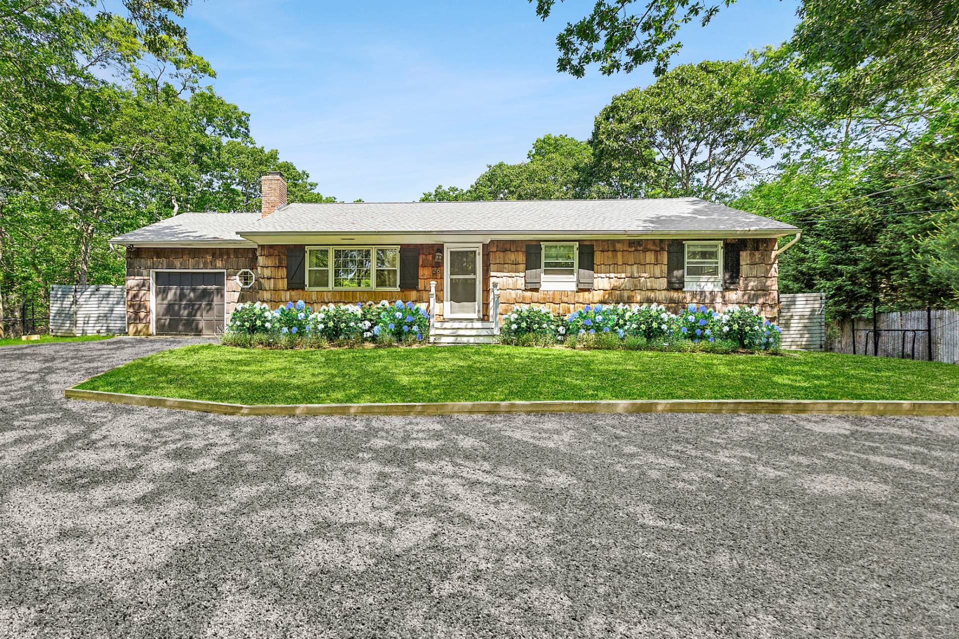 26 Whooping Hollow Road East Hampton, NY 11937 - Photo 2 of 18 a view of a house with a garden