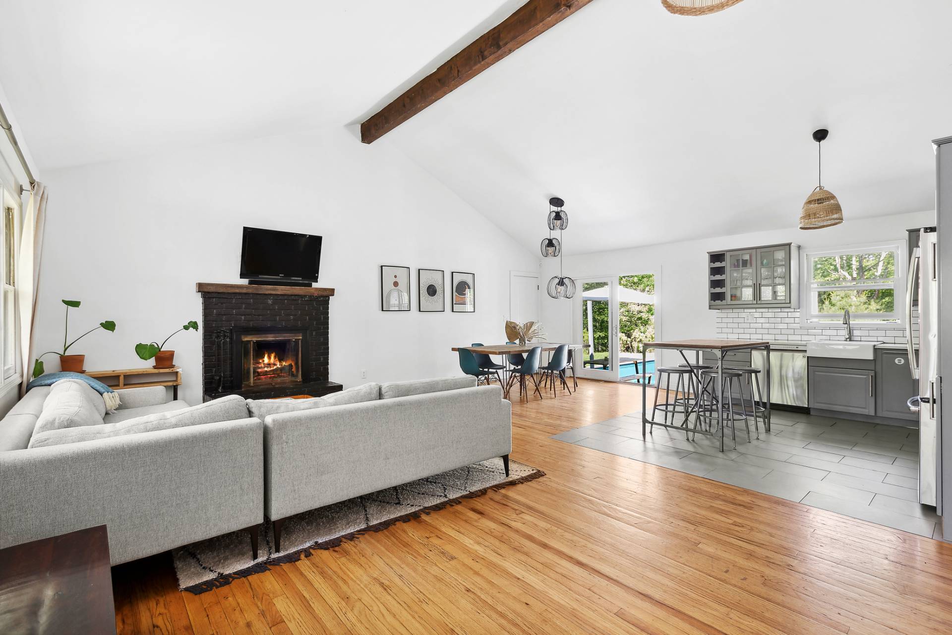 26 Whooping Hollow Road East Hampton, NY 11937 - Photo 3 of 18 a living room with furniture a fireplace and a flat screen tv