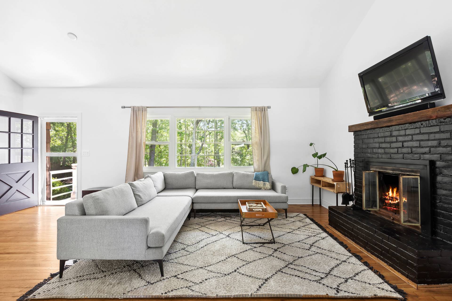 26 Whooping Hollow Road East Hampton, NY 11937 - Photo 5 of 18 a living room with furniture a flat screen tv and a fireplace