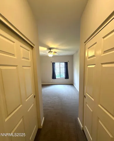 a view of hallway with a bathroom