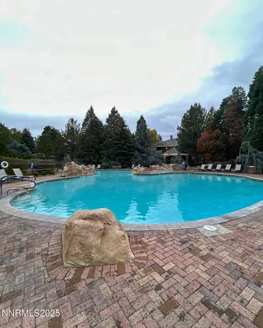 a view of a swimming pool with outdoor seating