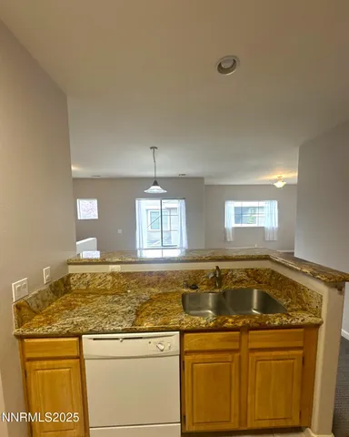 a view of a kitchen counter space sink and window
