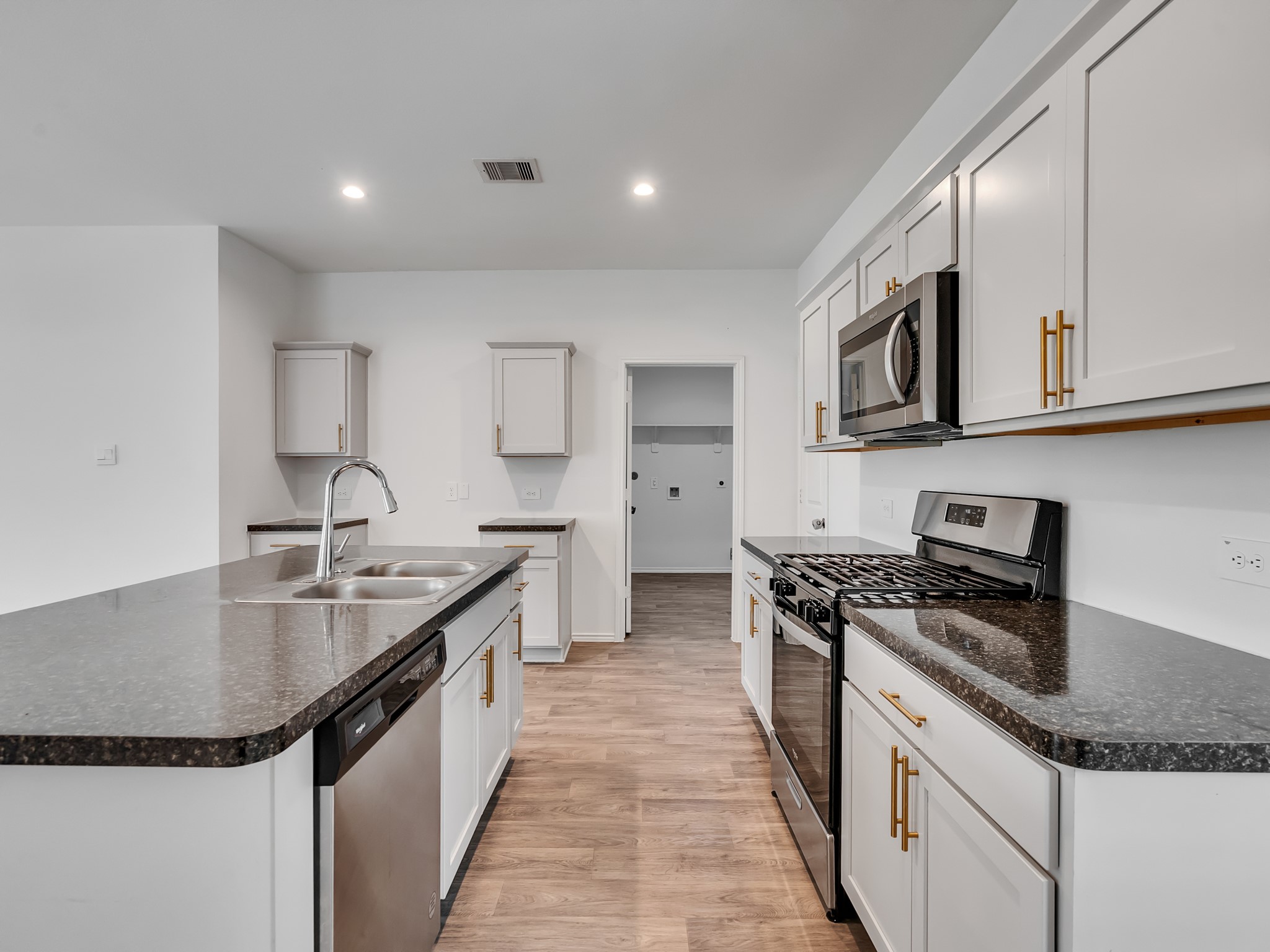 5431 Tuscany Hills Lane Spring, TX 77373 - Photo 17 of 22 a kitchen with stainless steel appliances granite countertop a sink stove and cabinets