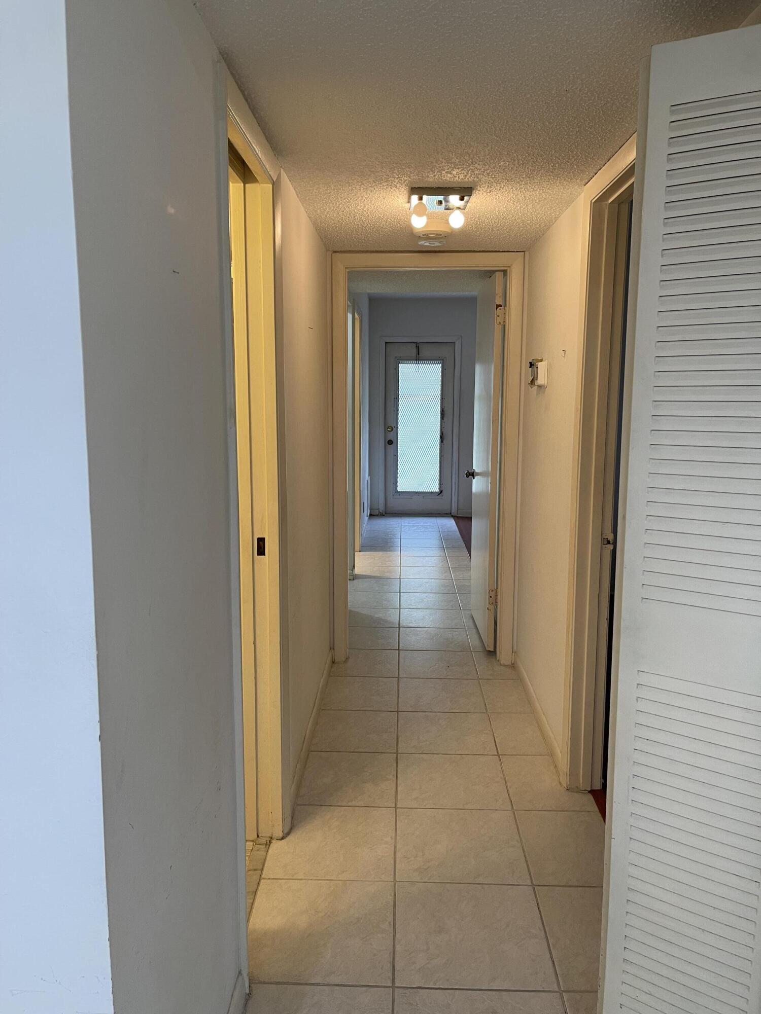 4530 Northwest 2nd Street, Unit D Delray Beach, FL 33445 - Photo 15 of 31 a view of a hallway with wooden floor and a bathroom