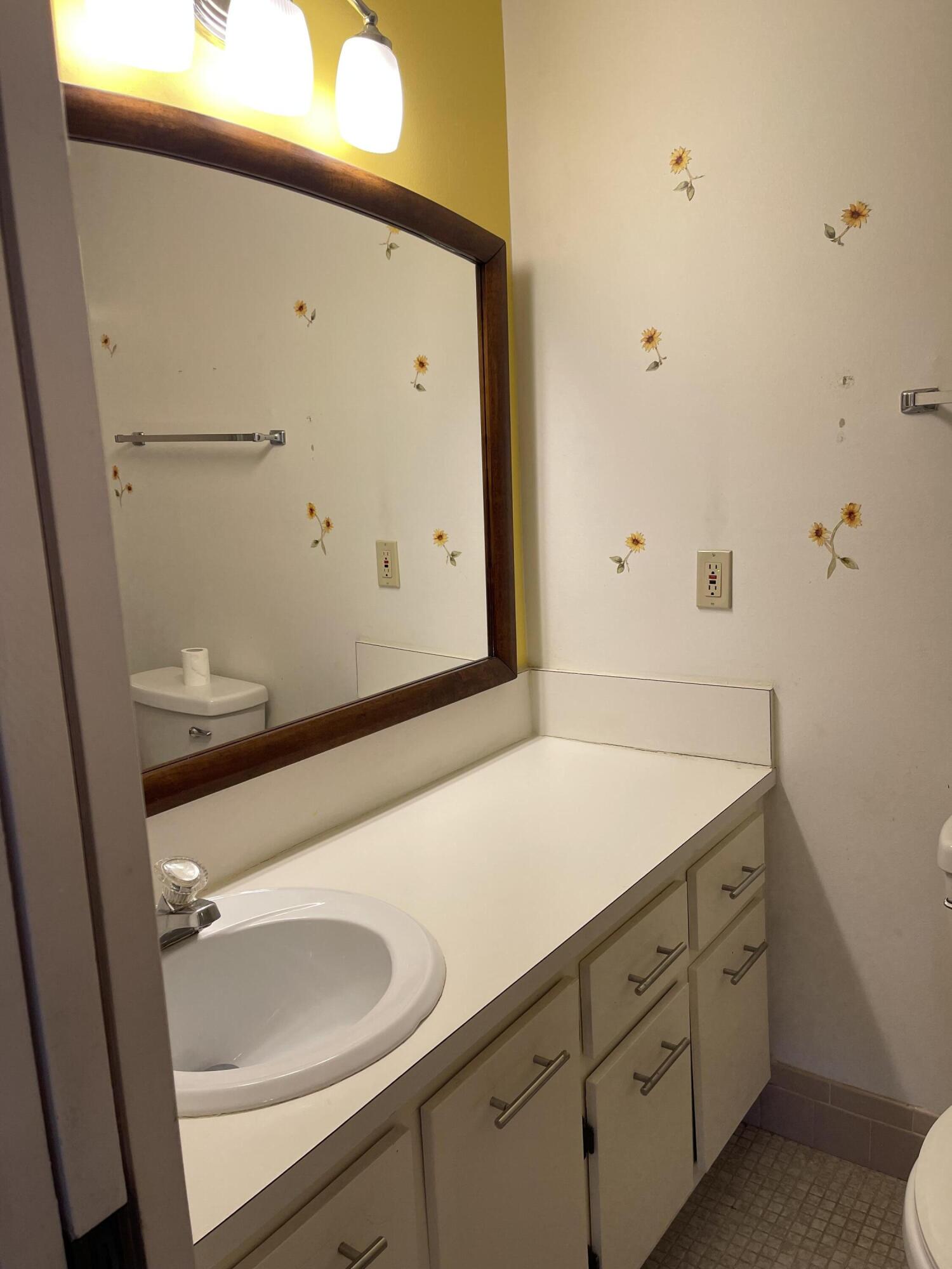 4530 Northwest 2nd Street, Unit D Delray Beach, FL 33445 - Photo 17 of 31 a bathroom with a sink and a mirror