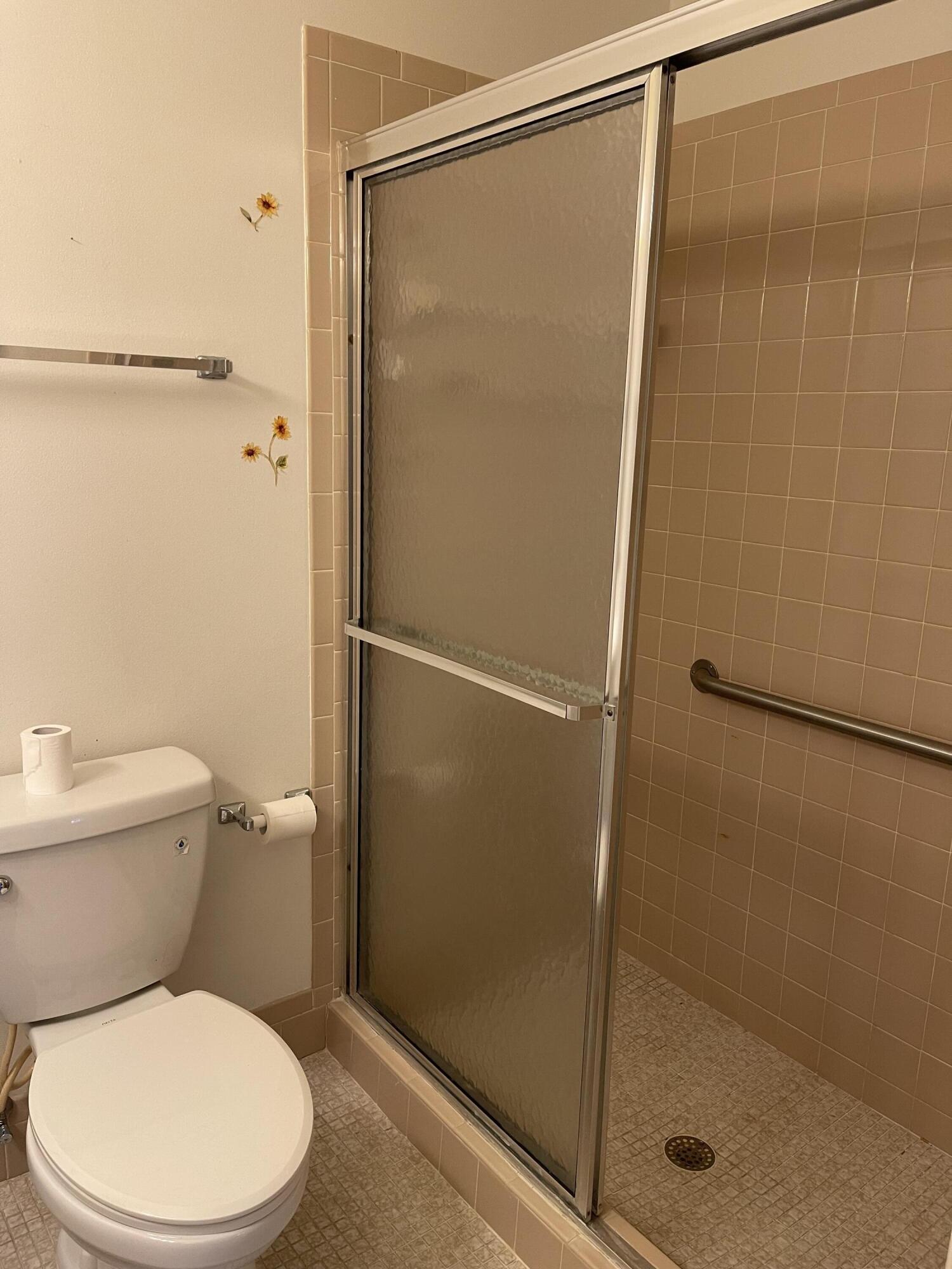 4530 Northwest 2nd Street, Unit D Delray Beach, FL 33445 - Photo 18 of 31 a bathroom with a shower a toilet and a shower