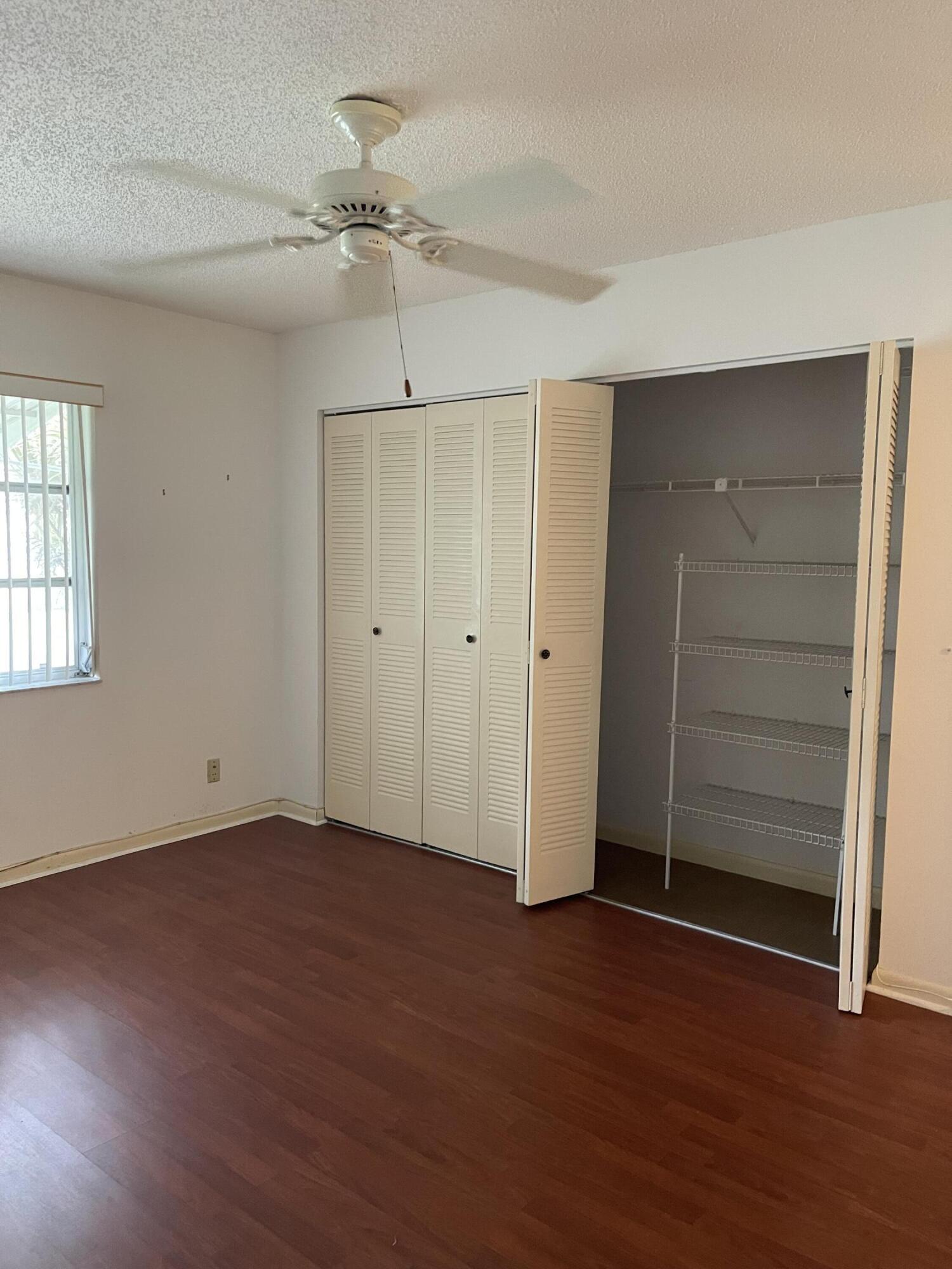 4530 Northwest 2nd Street, Unit D Delray Beach, FL 33445 - Photo 20 of 31 an empty room with wooden floor closet and windows