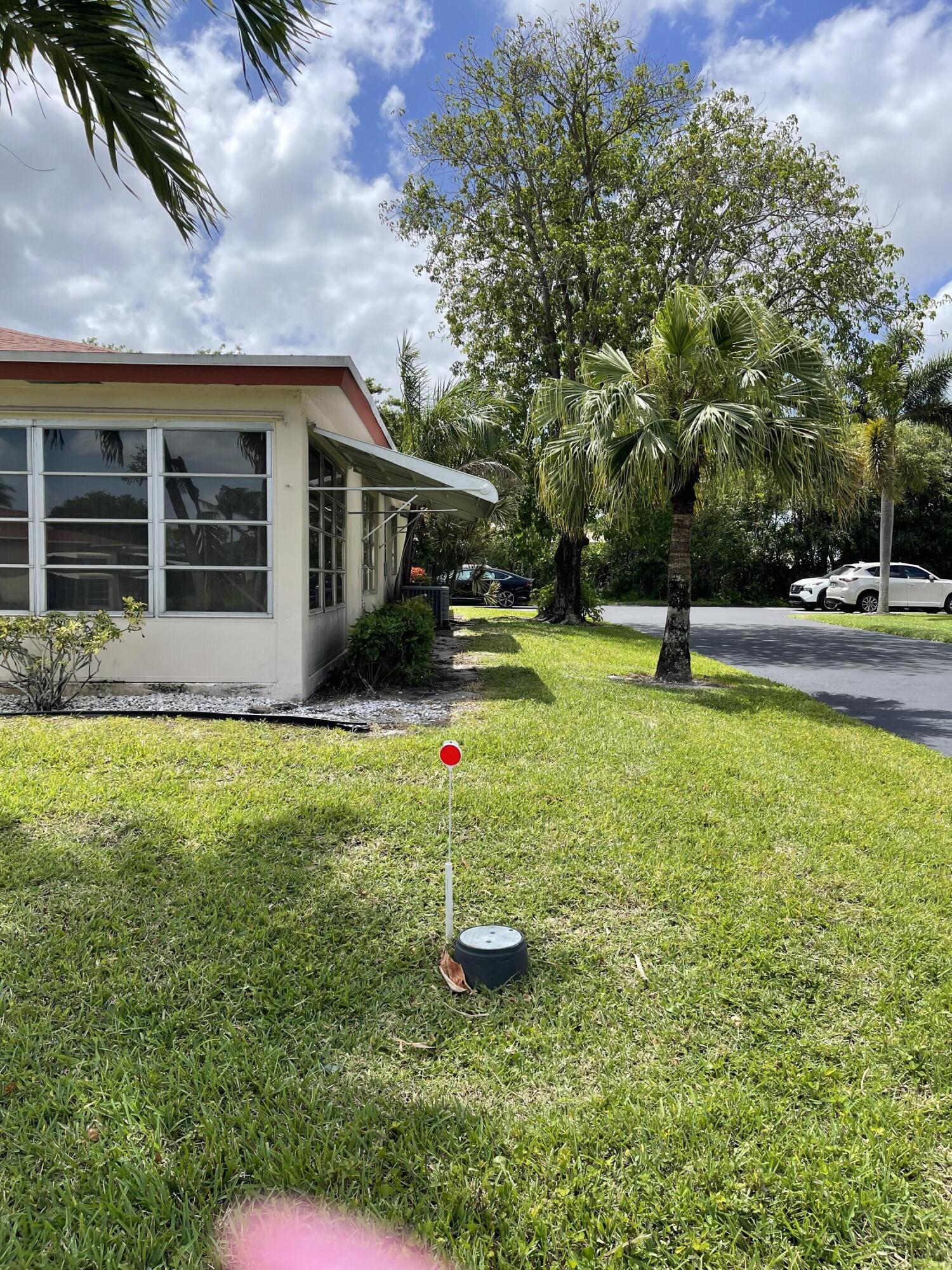 4530 Northwest 2nd Street, Unit D Delray Beach, FL 33445 - Photo 2 of 31 a view of a house with a yard porch and sitting area