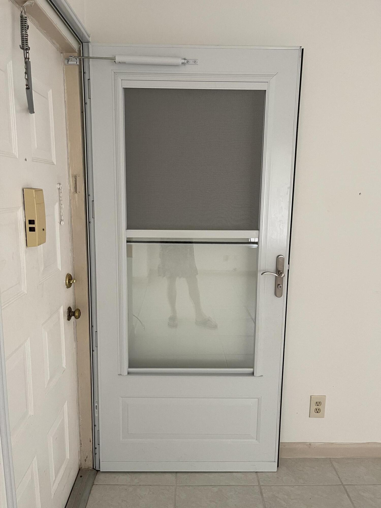 4530 Northwest 2nd Street, Unit D Delray Beach, FL 33445 - Photo 4 of 31 a bathroom with a glass shower door