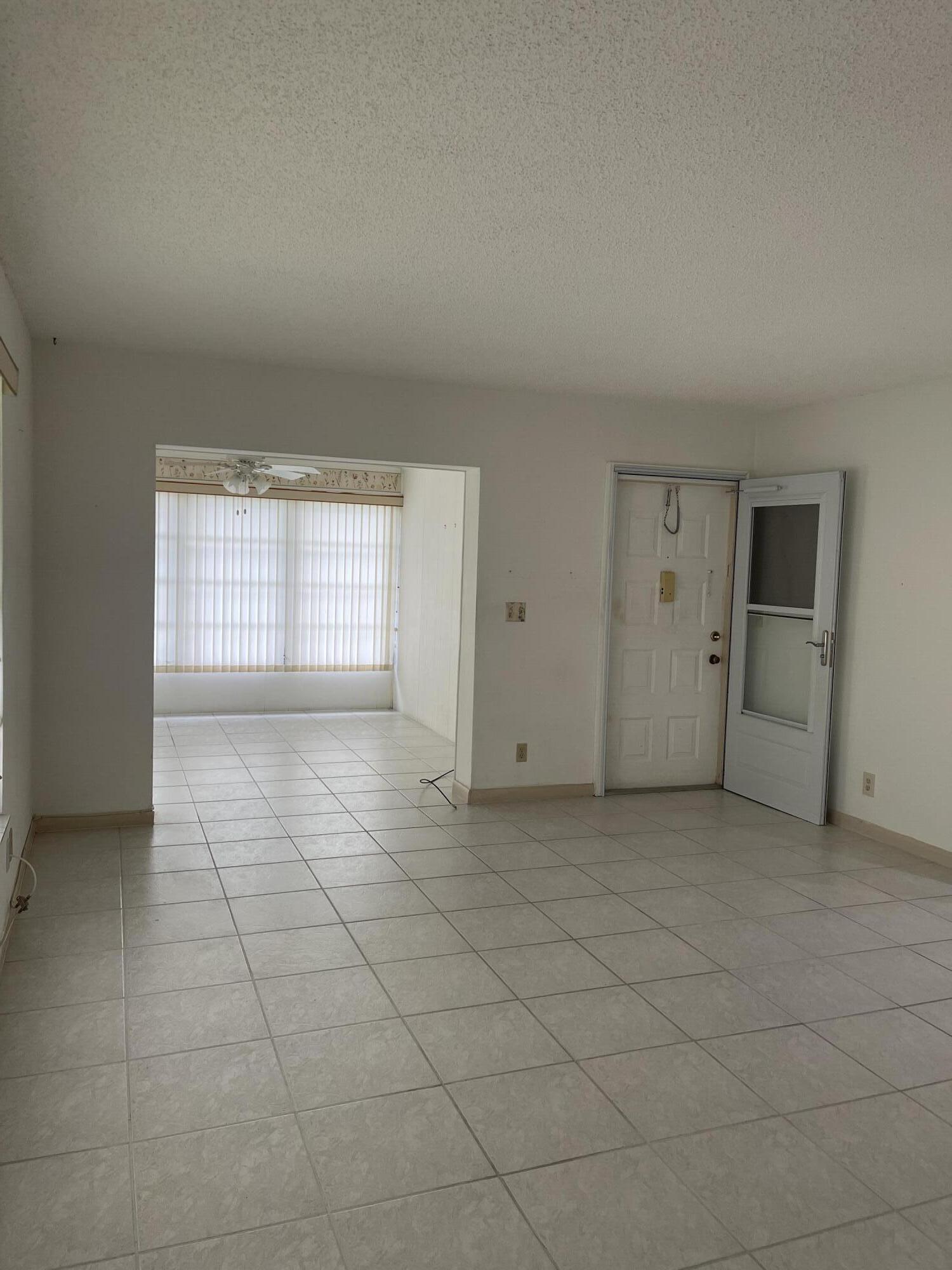 4530 Northwest 2nd Street, Unit D Delray Beach, FL 33445 - Photo 9 of 31 an empty room with windows and closet