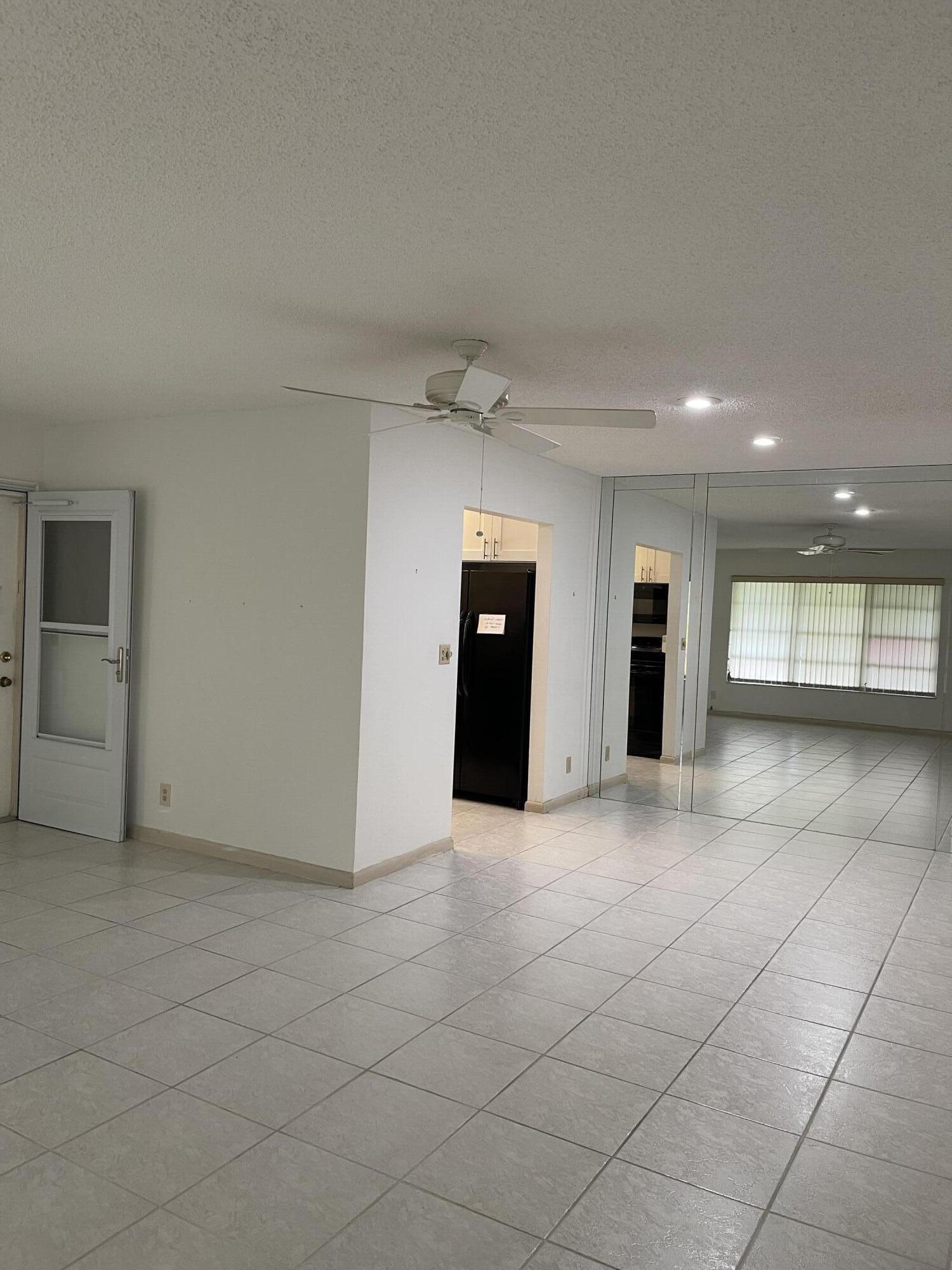 4530 Northwest 2nd Street, Unit D Delray Beach, FL 33445 - Photo 10 of 31 an empty room with kitchen and windows