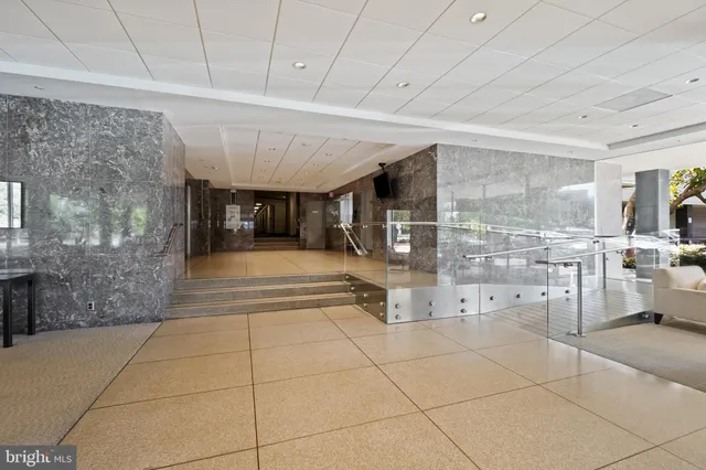 a lobby with furniture and a rug