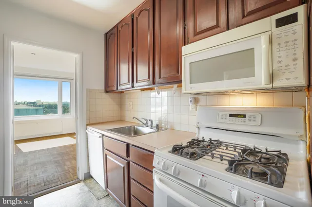 a kitchen with a stove a sink and a microwave