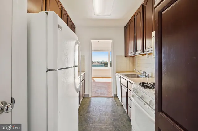 a kitchen with a refrigerator and a stove