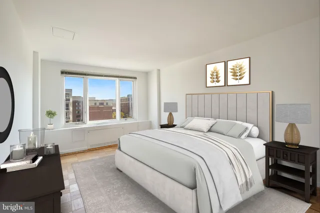 a bedroom with bed and a large window