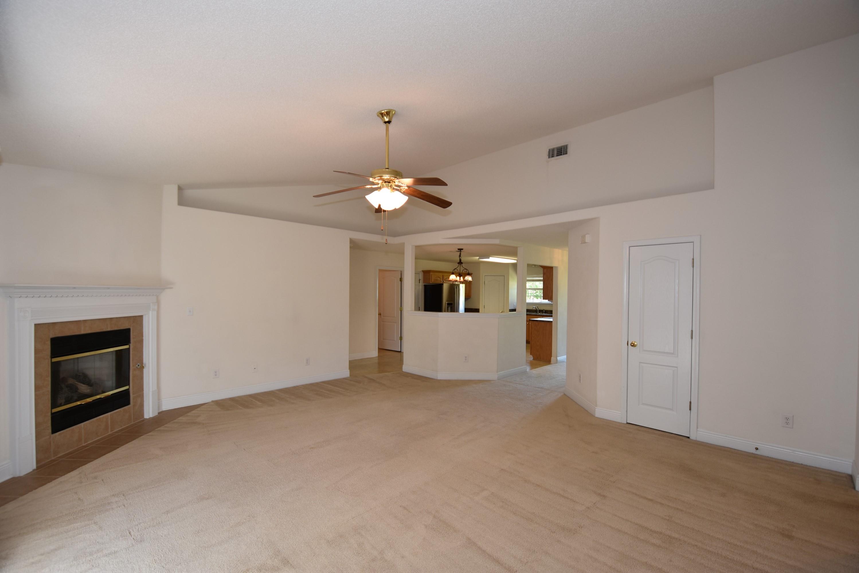 404 Swift Fox Run Crestview, FL 32536 - Photo 13 of 37 a view of an empty room with window and fire place