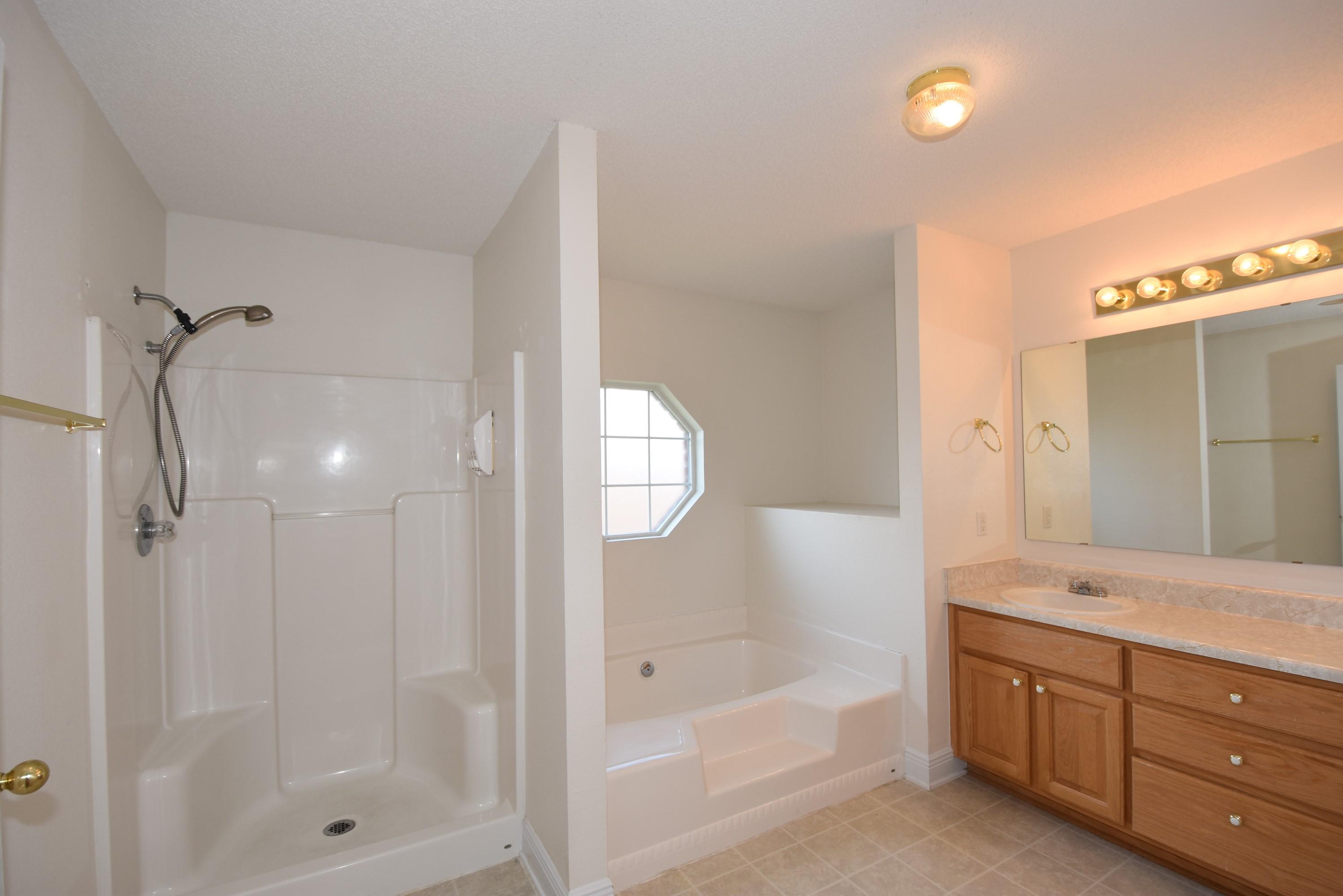 404 Swift Fox Run Crestview, FL 32536 - Photo 20 of 37 a bathroom with a tub shower vanity and a sink