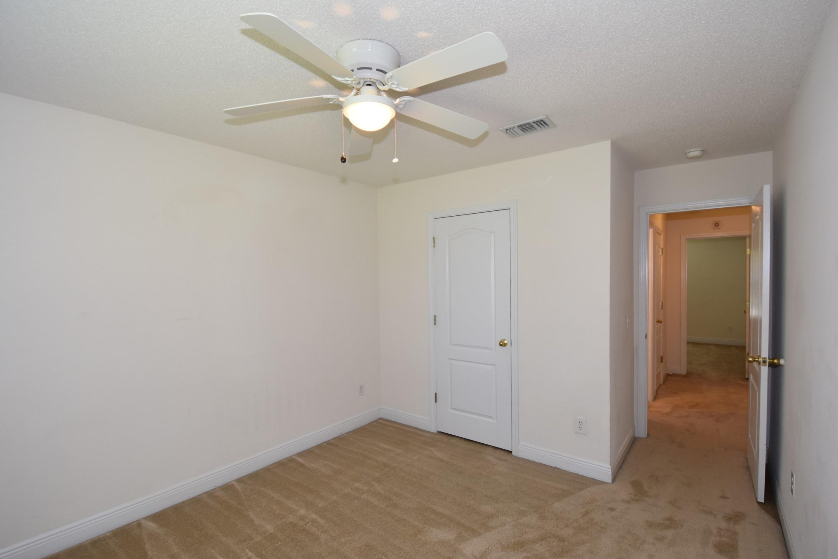 404 Swift Fox Run Crestview, FL 32536 - Photo 24 of 37 an empty room with a ceiling fan and a fan