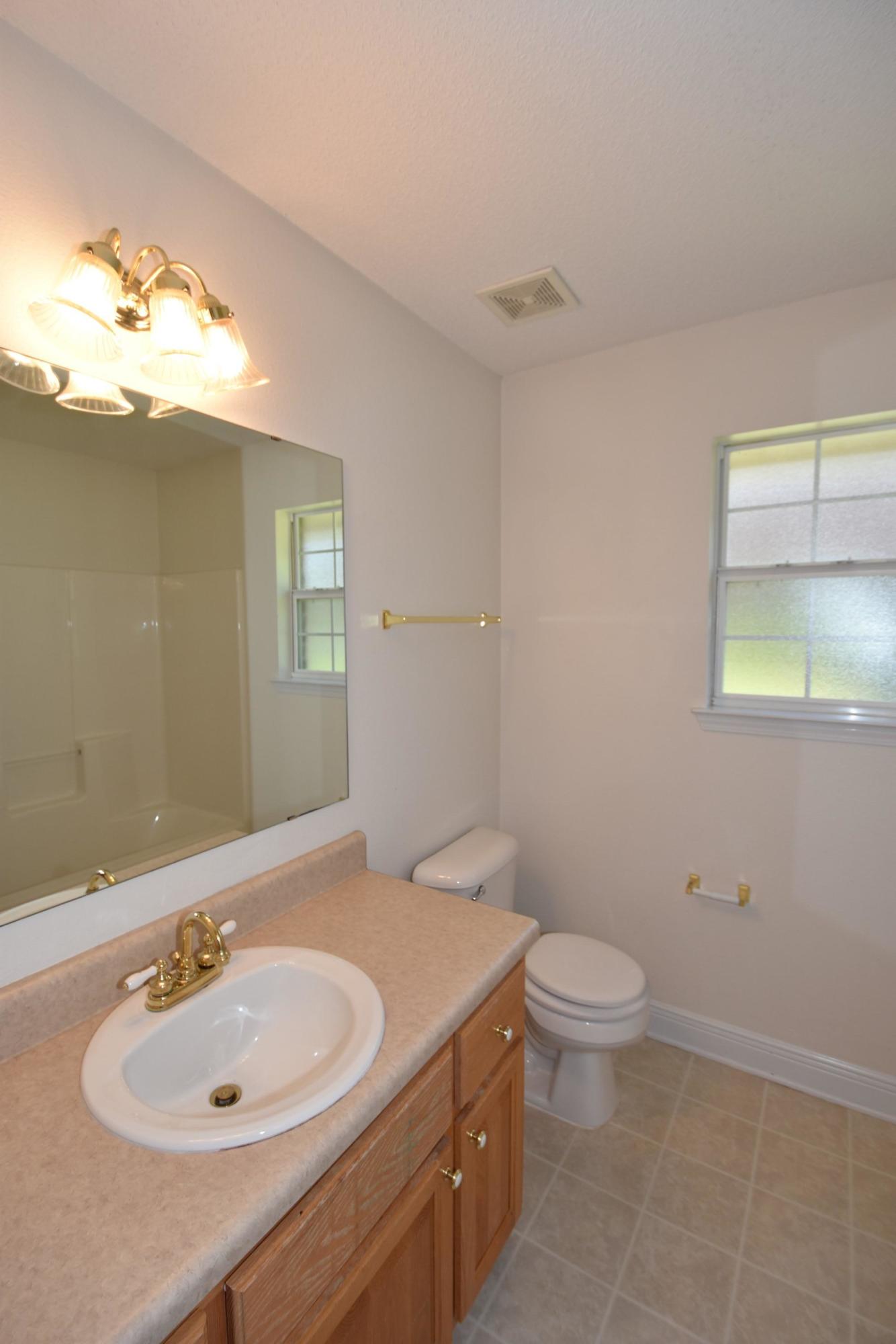 404 Swift Fox Run Crestview, FL 32536 - Photo 25 of 37 a bathroom with a sink toilet and mirror