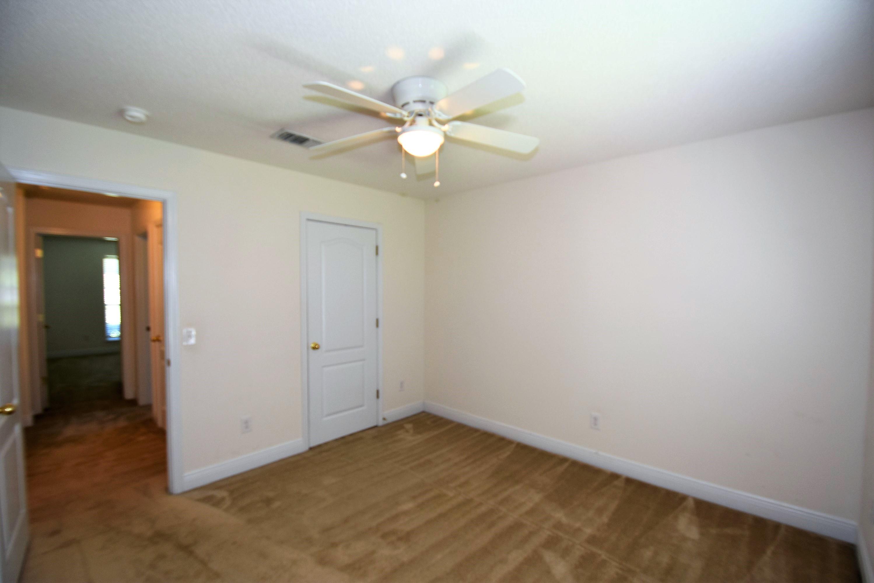404 Swift Fox Run Crestview, FL 32536 - Photo 27 of 37 an empty room with a fan and a fan