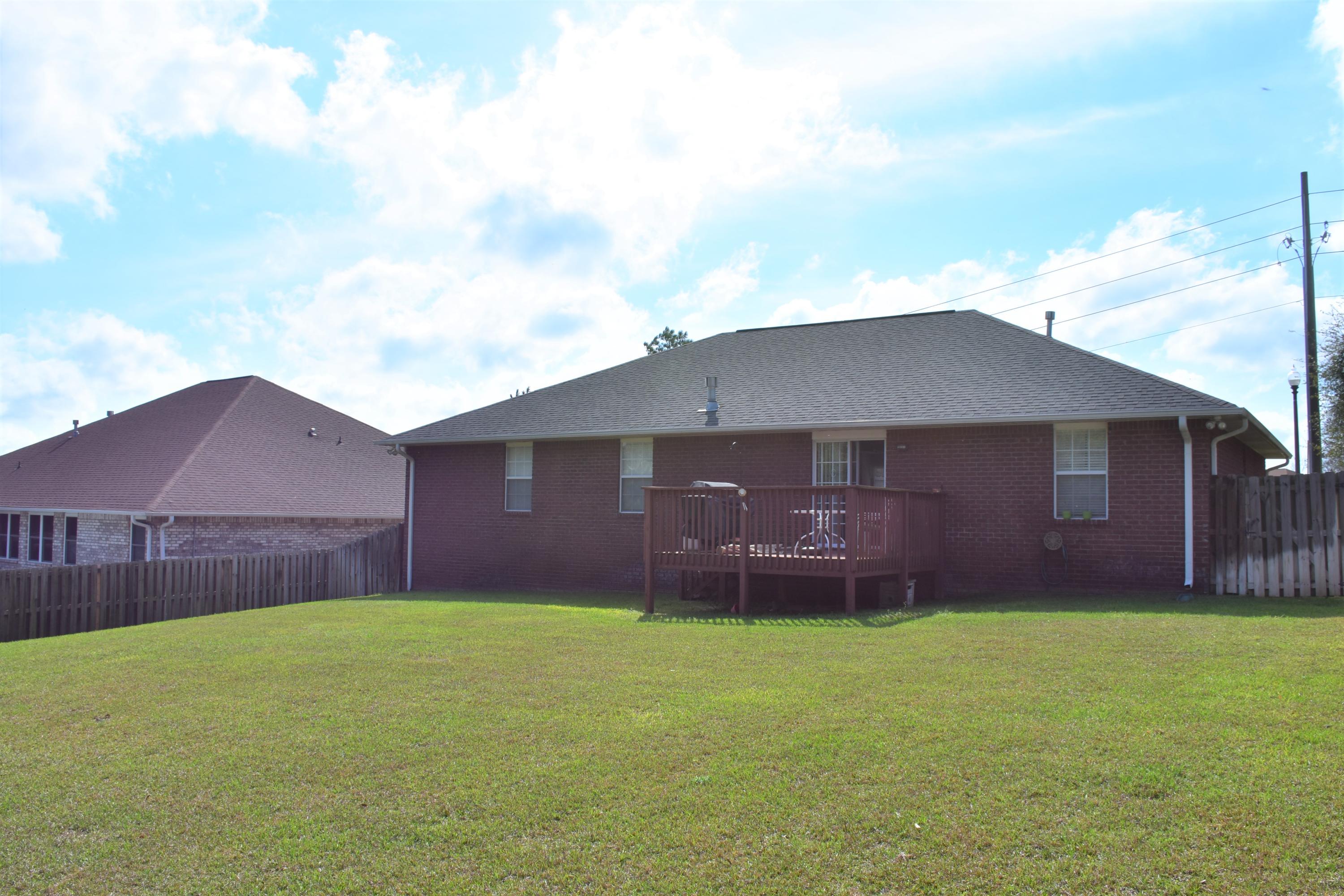 404 Swift Fox Run Crestview, FL 32536 - Photo 3 of 37 a front view of a house with a garden