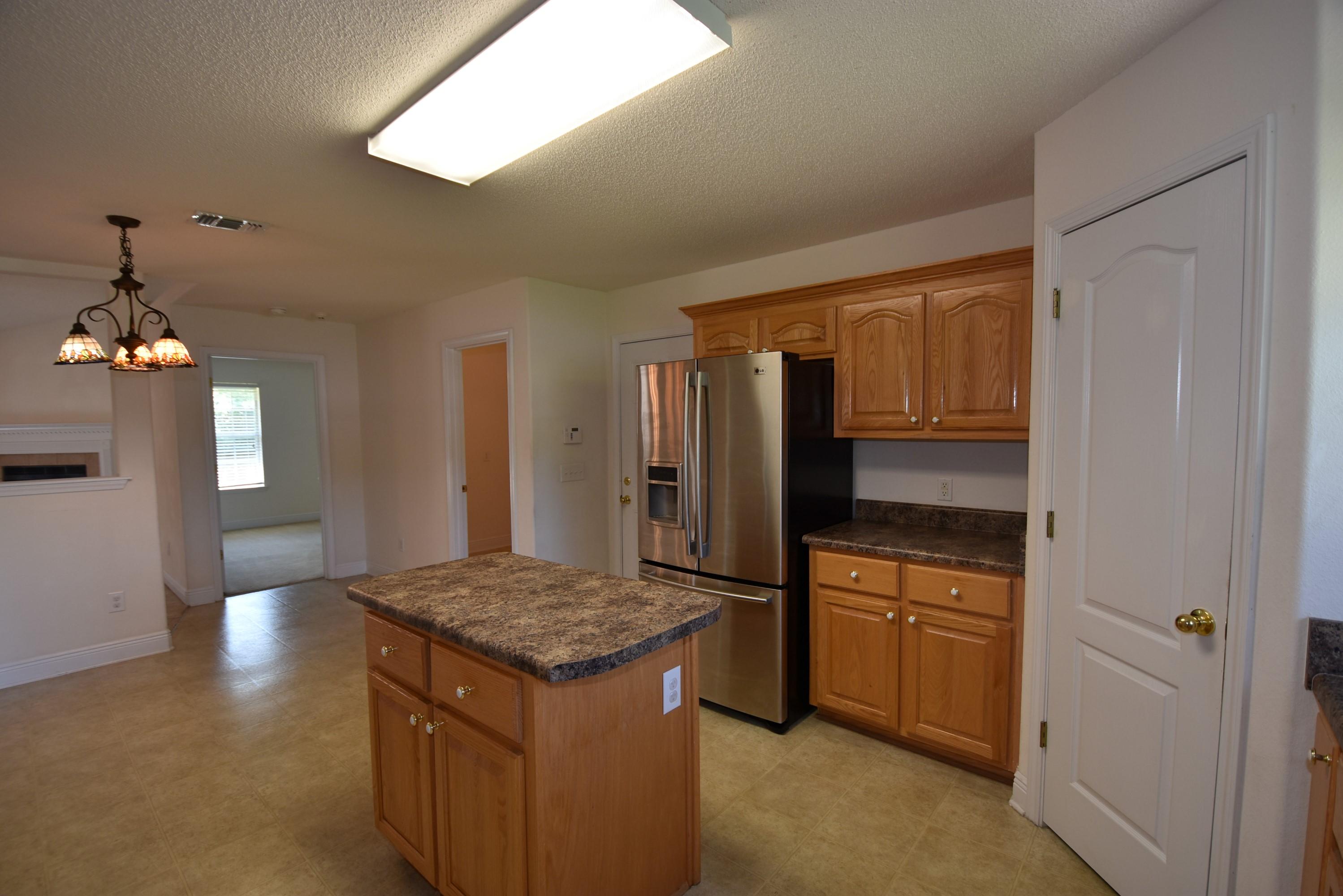 404 Swift Fox Run Crestview, FL 32536 - Photo 9 of 37 a kitchen with a sink and chandelier