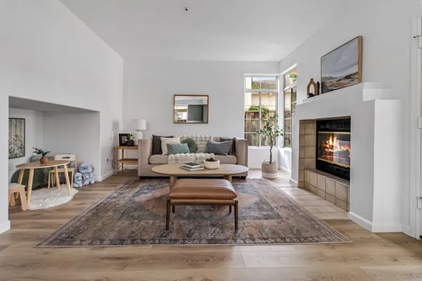 a living room with furniture and a fireplace