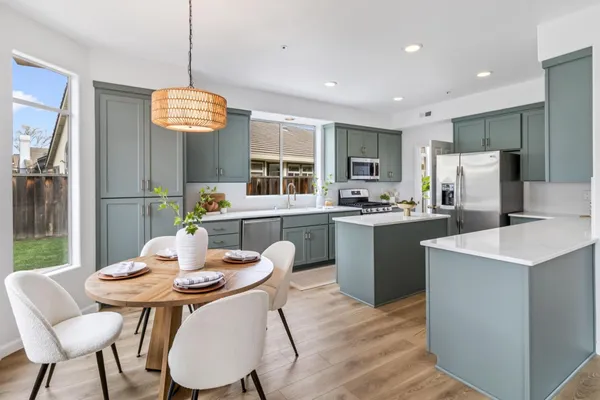 a kitchen with a dining table and chairs