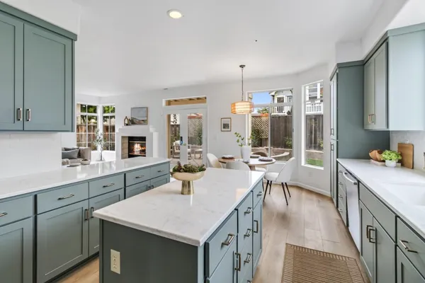 a kitchen with a table chairs stove and cabinets