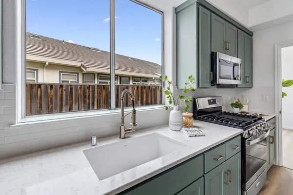 a kitchen with a sink a counter top space and cabinets