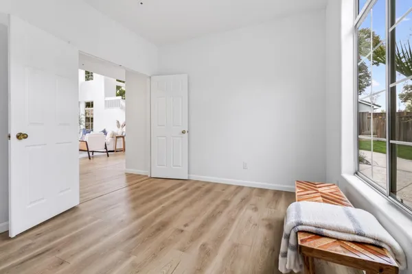 a view of a room with wooden floor and furniture