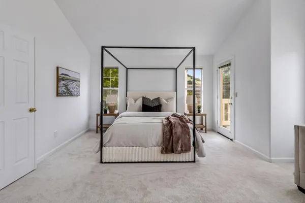a bedroom with a bed and a window