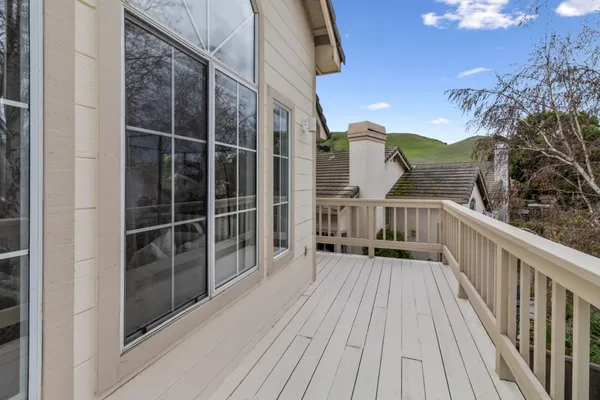 a view of balcony with wooden floor and fence