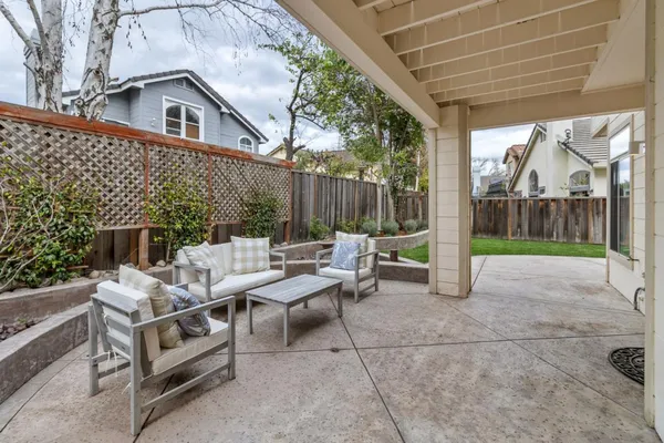 a view of a patio with a table and chairs