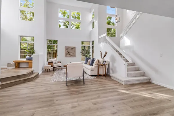 a living room with furniture and a stairs