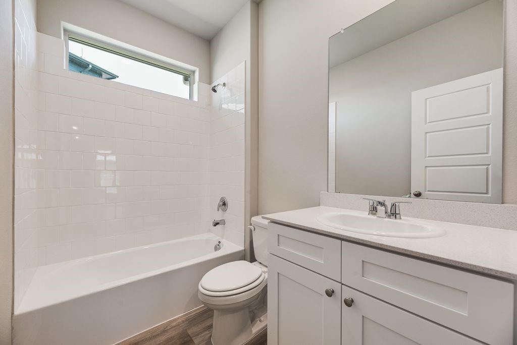 752 Rubicon Road Justin, TX 76247 - Photo 14 of 19 Bathroom featuring a vanity with white cabinetry and a white countertop, an integrated sink, and a chrome faucet