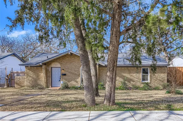 a front view of a house with a tree s