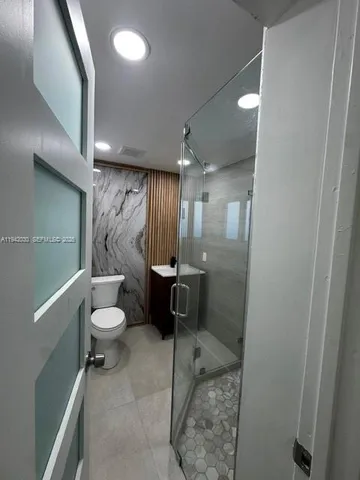 a bathroom with a toilet and a shower