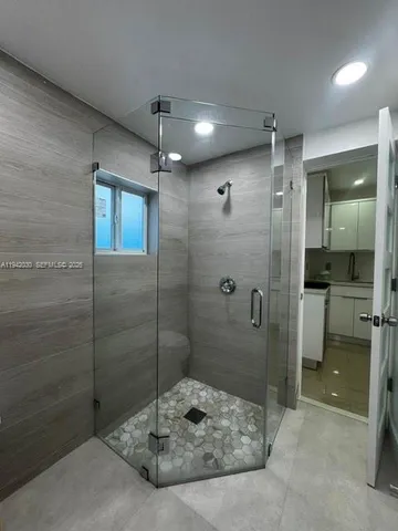 a bathroom with a shower and a sink